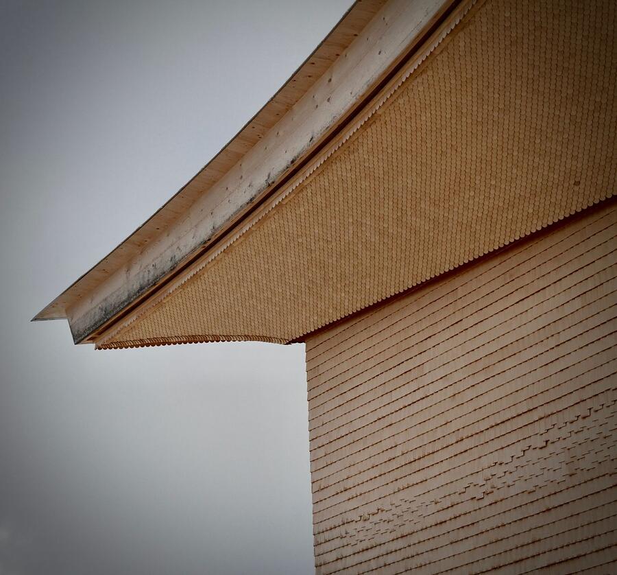 The corner of a soffit where two rooflines meet, seen from below